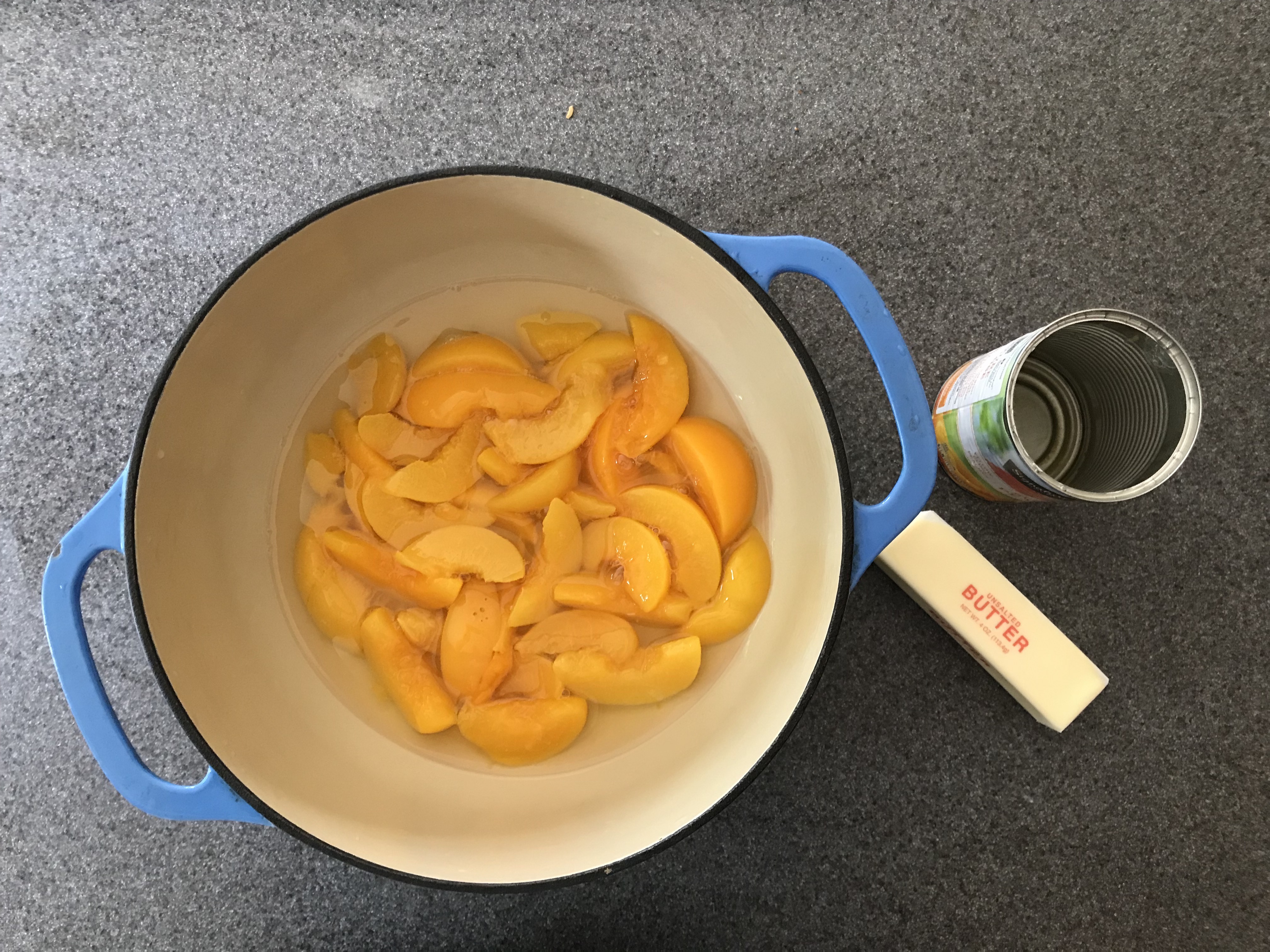 Canned sliced peaches in heavy syrup in a dutch oven