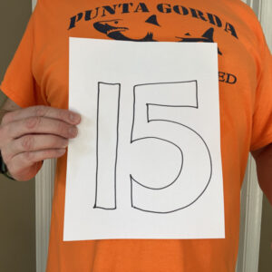 Liam Dempsey holding the number 15 written on a piece of paper.